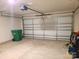 Attached garage with white paneled garage door and concrete floor at 1195 Winding Creek Rd, Salisbury, NC 28146
