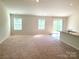 An expansive living room bathed in natural light, featuring a cozy carpet and an open layout at 1195 Winding Creek Rd, Salisbury, NC 28146