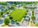 Aerial view of a neighborhood featuring a central green space surrounded by homes and streets at 12024 John Newton Dr, Davidson, NC 28036