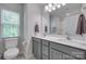 Bright bathroom with a double sink vanity, modern fixtures, and a large mirror at 12024 John Newton Dr, Davidson, NC 28036