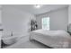 Bedroom with neutral carpet, bright window, and decorative wood accents at 12024 John Newton Dr, Davidson, NC 28036