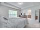 Bright bedroom with tray ceilings, large windows, and ensuite bath at 12024 John Newton Dr, Davidson, NC 28036