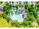 Overhead shot of a pristine community swimming pool and clubhouse, complete with umbrellas and lounge chairs at 12024 John Newton Dr, Davidson, NC 28036