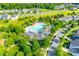 Aerial view of neighborhood swimming pool with clubhouse and green space perfect for relaxing and socializing at 12024 John Newton Dr, Davidson, NC 28036