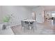 This dining area features a round table with four chairs, set on a neutral rug, adjacent to an open floorplan at 12024 John Newton Dr, Davidson, NC 28036