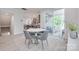 This dining area features a round table with four chairs, and a view to the kitchen and outdoor patio at 12024 John Newton Dr, Davidson, NC 28036