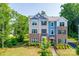 Charming townhome featuring brick accents, complemented by lush green landscaping, and dark shutters at 12024 John Newton Dr, Davidson, NC 28036