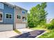 Well-maintained townhome showcasing a private balcony, garage, and neat landscaping at 12024 John Newton Dr, Davidson, NC 28036