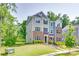 Exterior view of a two-story townhome featuring brick and siding with a well-maintained lawn at 12024 John Newton Dr, Davidson, NC 28036