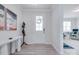 Welcoming foyer boasts a white bench, coat rack, and durable laminate flooring at 12024 John Newton Dr, Davidson, NC 28036