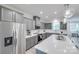 This spacious kitchen features gray cabinets, stainless steel appliances, and a large island with a white countertop at 12024 John Newton Dr, Davidson, NC 28036