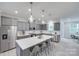 This spacious kitchen features gray cabinets, stainless steel appliances, and a large island with seating and pendant lighting at 12024 John Newton Dr, Davidson, NC 28036