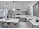 This spacious kitchen features gray cabinets, stainless steel appliances, a large island, and an open concept design at 12024 John Newton Dr, Davidson, NC 28036