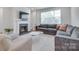 Inviting living room has a fireplace, large windows, and comfortable seating at 12024 John Newton Dr, Davidson, NC 28036