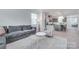 Cozy living room with neutral tones, opening to kitchen with island seating, stainless appliances, and light gray cabinetry at 12024 John Newton Dr, Davidson, NC 28036