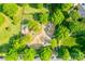 Aerial view of a lovely community playground with mature trees and modern play equipment for children at 12024 John Newton Dr, Davidson, NC 28036
