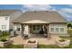 Backyard features an inviting brick patio with a covered pergola and landscaped planters at 132 Hillston Ln, Mooresville, NC 28115