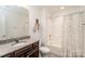 Clean bathroom features granite counters, white shower and tub, and modern fixtures at 132 Hillston Ln, Mooresville, NC 28115