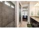Modern tiled shower in a bathroom, next to the bedroom at 132 Hillston Ln, Mooresville, NC 28115