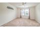 Bright, carpeted bedroom with a ceiling fan, large window, and neutral decor at 132 Hillston Ln, Mooresville, NC 28115