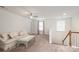 Bright and airy bonus room with neutral carpet, ceiling fan and staircase access at 132 Hillston Ln, Mooresville, NC 28115