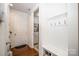 Entryway with a coat rack, wooden floors and white walls, leads to laundry room at 132 Hillston Ln, Mooresville, NC 28115