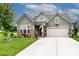 Charming home with a two-car garage, beautiful stone accents, and a well-manicured front yard at 132 Hillston Ln, Mooresville, NC 28115
