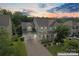 Overhead view of a two-story home, a well-maintained yard and a two-car garage at sunset at 133 Yellowbell Rd, Mooresville, NC 28117