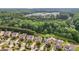 Aerial view of the homes backing to a greenbelt, pond, and a school in the distance at 133 Yellowbell Rd, Mooresville, NC 28117