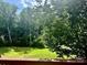 Private backyard featuring a well-maintained lawn, trees, and a deck at 133 Yellowbell Rd, Mooresville, NC 28117