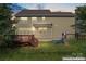 Backyard with a wooden deck, playset, and a well-maintained lawn at 133 Yellowbell Rd, Mooresville, NC 28117
