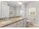 Well-lit bathroom featuring a double sink with granite countertops and a separate shower at 133 Yellowbell Rd, Mooresville, NC 28117