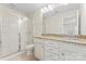 Bathroom featuring a double sink with granite countertops and a glass-enclosed shower at 133 Yellowbell Rd, Mooresville, NC 28117