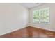 Bedroom with hardwood floors, a bright window, and neutral paint, creating a serene atmosphere at 133 Yellowbell Rd, Mooresville, NC 28117