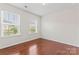 Bedroom featuring hard wood floors and two large windows at 133 Yellowbell Rd, Mooresville, NC 28117