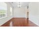 Elegant dining room with hardwood floors, wainscoting, a chandelier, and natural light from the window at 133 Yellowbell Rd, Mooresville, NC 28117