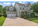 Traditional two-story home with a two-car garage, front porch and well-manicured landscaping at 133 Yellowbell Rd, Mooresville, NC 28117