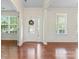 Bright foyer featuring hardwood floors, a decorative front door, and a view into the living spaces at 133 Yellowbell Rd, Mooresville, NC 28117