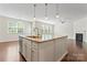 Well-designed kitchen island with granite countertops, stainless steel appliances, and open flow to the living areas at 133 Yellowbell Rd, Mooresville, NC 28117