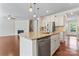 Stylish kitchen island featuring granite countertops, stainless steel appliances, and pendant lighting at 133 Yellowbell Rd, Mooresville, NC 28117