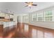 Spacious living room with hardwood floors, large windows, and an open layout to the kitchen at 133 Yellowbell Rd, Mooresville, NC 28117