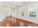 Living room featuring hardwood floors, white walls, and natural light filtering through the windows at 133 Yellowbell Rd, Mooresville, NC 28117