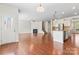 Inviting living space showcasing hardwood floors, a fireplace, and a seamless connection to the kitchen at 133 Yellowbell Rd, Mooresville, NC 28117