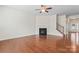 Inviting living room showcasing hardwood floors, a fireplace, and a staircase leading to the upper level at 133 Yellowbell Rd, Mooresville, NC 28117