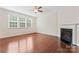 Bright living room featuring hardwood floors, a cozy fireplace, and ample natural light from large windows at 133 Yellowbell Rd, Mooresville, NC 28117