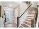 Bright hallway with stairs, wood floors, decorative doors, and an entryway visible at the end of the hall at 1432 Ardmore Dr # 341, Sherrills Ford, NC 28673