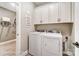 Bright laundry room with modern washer and dryer, ample cabinet storage, and unique decor at 1432 Ardmore Dr # 341, Sherrills Ford, NC 28673