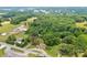 Aerial view showcasing a single-story home surrounded by mature trees, located near roads and other buildings at 1529 Stony Point Rd, Shelby, NC 28150