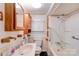 Cozy bathroom featuring a shower/tub combo and wooden cabinets for storage at 1529 Stony Point Rd, Shelby, NC 28150