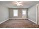Bedroom with a neutral color scheme, ceiling fan, a window, and closet door at 1529 Stony Point Rd, Shelby, NC 28150